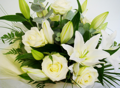 Timeless Beauty - This Lily and Rose Hand-Tied bouquet is absolutely stunning in White and Cream!

The long stemmed Roses and heavily scented oriental Lilies are perfect together as they complement each other to create a stiking floral display. The beautiful blooms are teamed up with mixed foliage.

The Hand-Tied bouquet is arranged in the hand and tied in a bunch, with the stems cut level to create a sprial effect. The stems are wrapped securely with patterned cellophane and ribbon to hold a water reservoir so the flowers are delivered in water.

The flowers are gift wrapped in colour co-ordinated tissue paper and patterened cellophane. Together with the flower food to ensure longer life and your personal card message, this is the complete package which will sure to be admired by all!

These beautiful blooms are delivered daily fresh from the Dutch auctions, so you can be rest assured you will be sending the best quality of flowers there is.