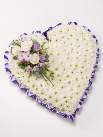 Based Heart - At Sarah Coxon Floral Design we are delighted to present this product available for flower delivery in Mid and North Norfolk. 

A based heart is a traditional funeral tribute, it is based in white Chrysanthemums, and is edged in hand pleated ribbon in a colour co-ordinating waterproof ribbon. The spray of flowers on top of the heart is raised above the Chrysanthemums and includes a beautiful selection of Roses, spray Carnations and other flowers to complement the design. 

The flowers are arranged in water retaining foam (oasis) to ensure maximum freshness. 

Standard - approx size 14"

Deluxe - approx size 17"

Luxury - approx size 19"

We deliver directly to all of the local funeral directors and will contact them to confirm a delivery time. 

Our flowers at Sarah Coxon Floral Design arrive fresh from the Dutch auctions every day so you can be rest assured we are using the best quality of flowers available. 

If you would like to choose a colour scheme, please state this in the special request box. Suggested colour schemes are red and white, yellow and white, pink and white and peach and white. If no colours have been selected we will use the same colours as the picture.