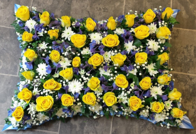Mixed Flower Pillow - At Sarah Coxon Floral Design we are delighted to present this product available for flower delivery in Mid and North Norfolk.

A mixed flower pillow is a modern twist on a traditional funeral tribute. It is full of mixed flowers, which includes Roses, Spray Carnations and other flowers which have been thoughtfully selected to complement the design. It is edged in hand pleated ribbon in a colour co-ordinating waterproof ribbon. 

The flowers are arranged in water retaining foam (oasis) to ensure maximum freshness. 

Standard - approx size 12"x 18"

Deluxe - approx size 14"x 21"

Luxury - approx size 17" x 24"

We deliver directly to all of the local funeral directors and will contact them to confirm a delivery time. 

There will be at least 4 varieties of flowers and foliage which will have been thoughtfully selected to ensure they complement each other perfectly. Our flowers at Sarah Coxon Floral Design arrive fresh from the Dutch auctions every day so you can be rest assured we are using the best quality of flowers available. 

If you would like to choose a colour scheme, please state this in the special request box. If no colours have been selected we will use the same colours as the picture.