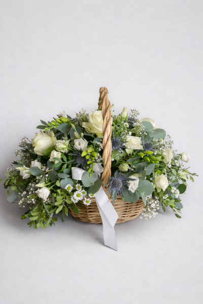 Ivory Grace Basket - An elegant basket arrangement in white and a touch of blue thistle. 
The basket may differ from the one shown, but this will not affect the overall look of this stunning display.